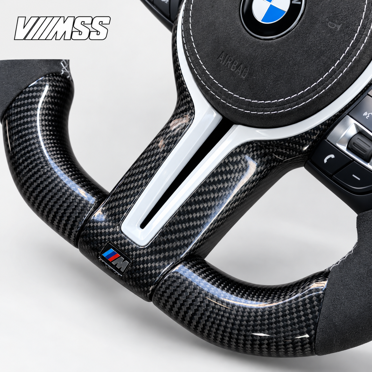 BMW F-Series White-Stripe Carbon Fibre & Alcantara Steering Wheel — Centre trim and lower rim detail; VMSS studio close-up