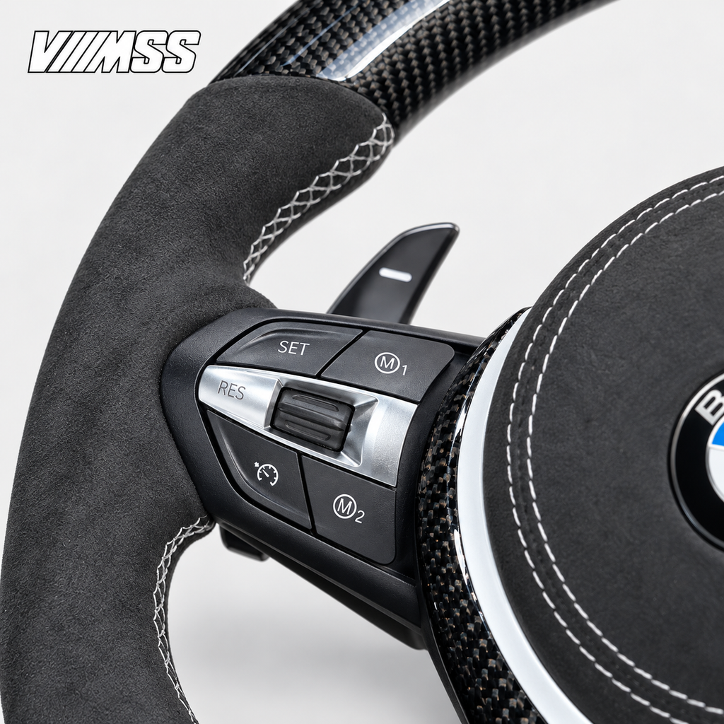BMW F-Series White-Stripe Carbon Fibre & Alcantara Steering Wheel — Buttons and visible paddle detail; VMSS studio close-up