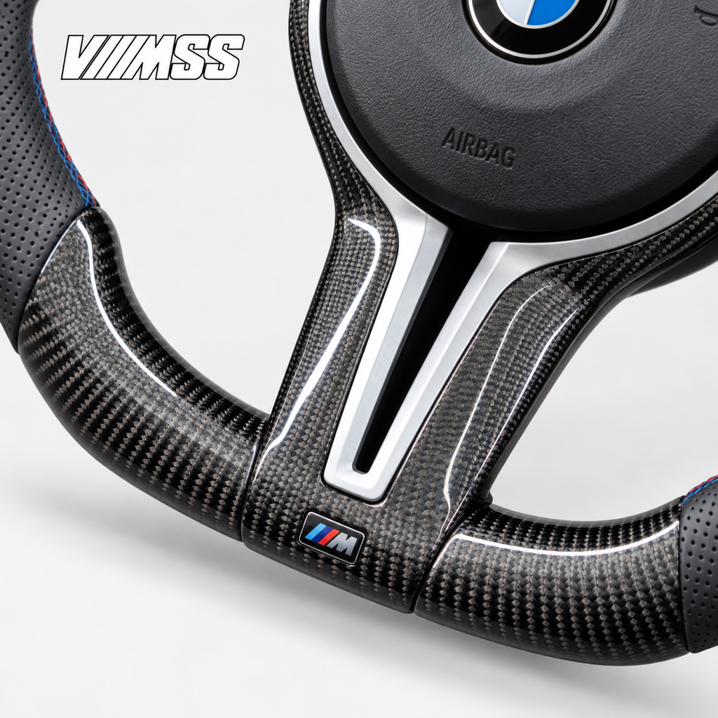 BMW F-Series M-Stripe Carbon Fibre & Perforated Leather — Round Steering Wheel — Centre trim and lower rim detail; VMSS studio close-up