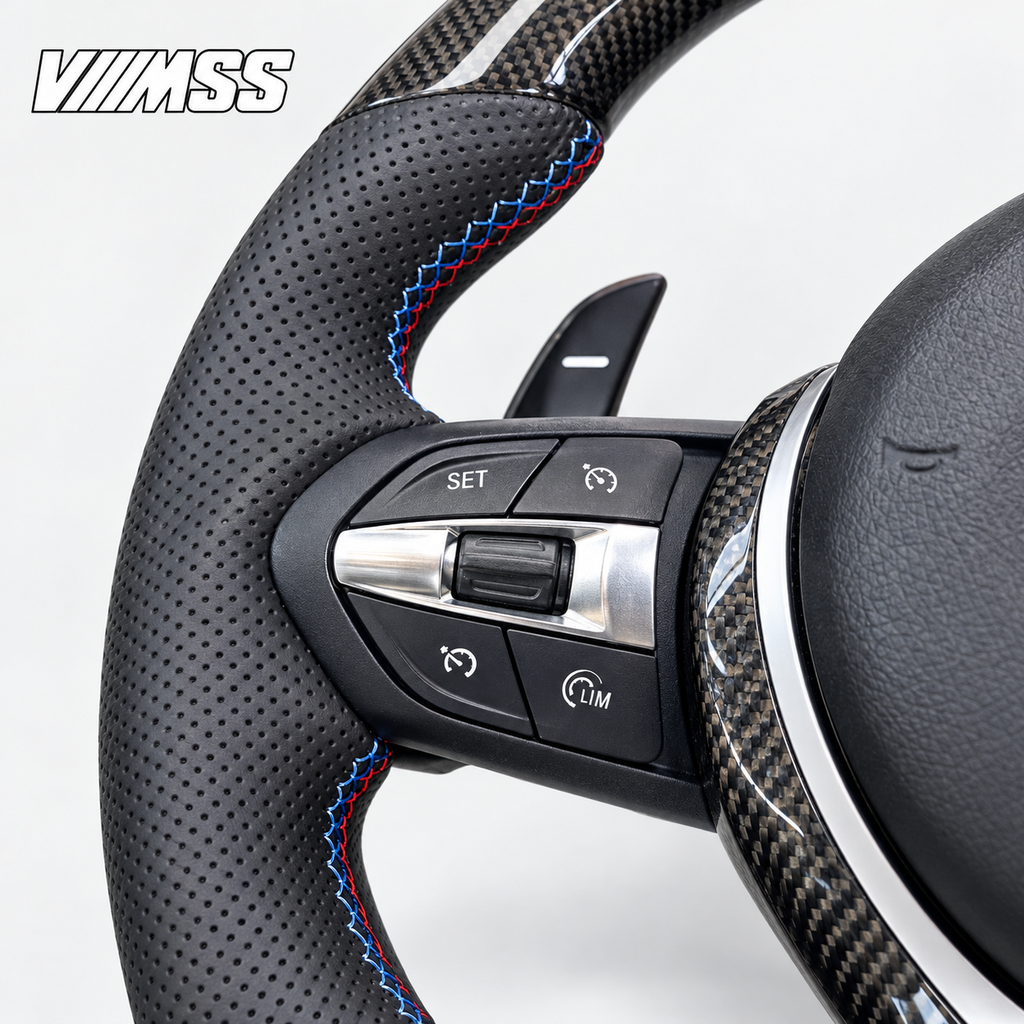 BMW F-Series M-Stripe Carbon Fibre & Perforated Leather — Round Steering Wheel — Buttons and visible paddle detail; VMSS studio close-up