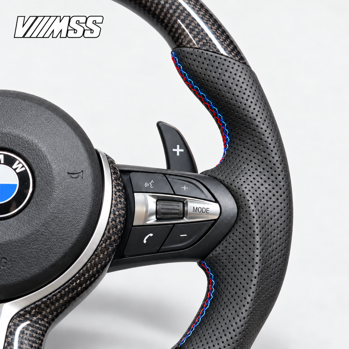 BMW F-Series M-Stripe Carbon Fibre & Perforated Leather — Round Steering Wheel — Grip, stitching and right control detail; VMSS studio close-up