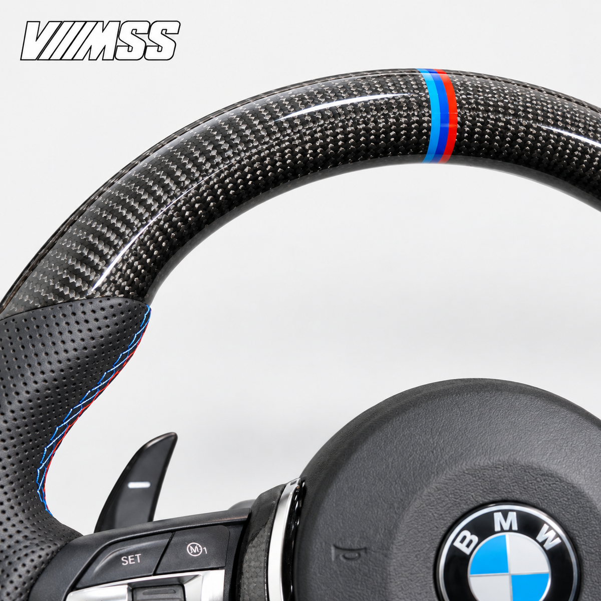 BMW F-Series M-Stripe Carbon Fibre & Perforated Leather — Round Steering Wheel — Upper rim and 12 o’clock detail; VMSS studio close-up