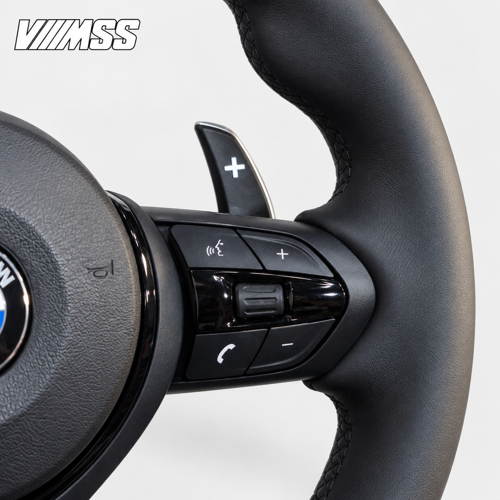 BMW F-Series Nappa Leather Sport — Black Trim Steering Wheel — Grip, stitching and right control detail; VMSS studio close-up
