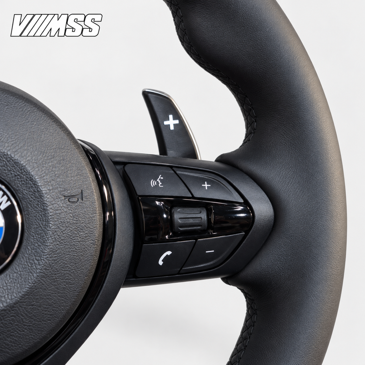 BMW F-Series Nappa Leather Sport — Black Trim Steering Wheel — Grip, stitching and right control detail; VMSS studio close-up