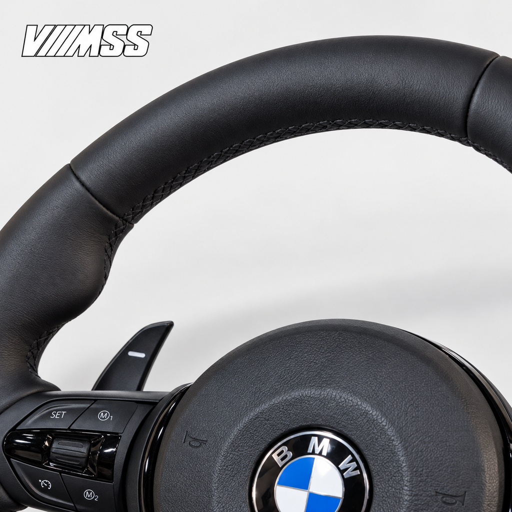 BMW F-Series Nappa Leather Sport — Black Trim Steering Wheel — Upper rim and 12 o’clock detail; VMSS studio close-up