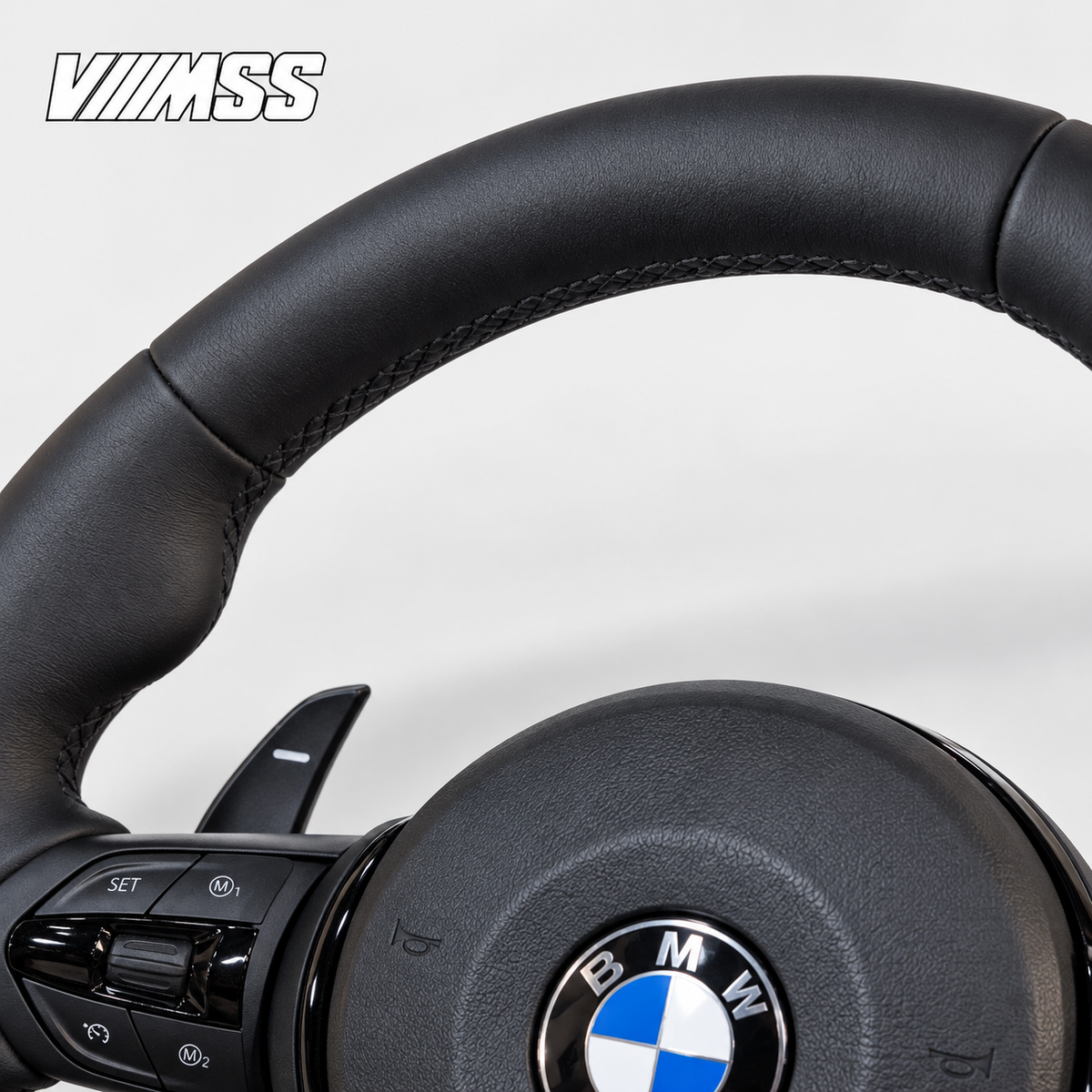 BMW F-Series Nappa Leather Sport — Black Trim Steering Wheel — Upper rim and 12 o’clock detail; VMSS studio close-up