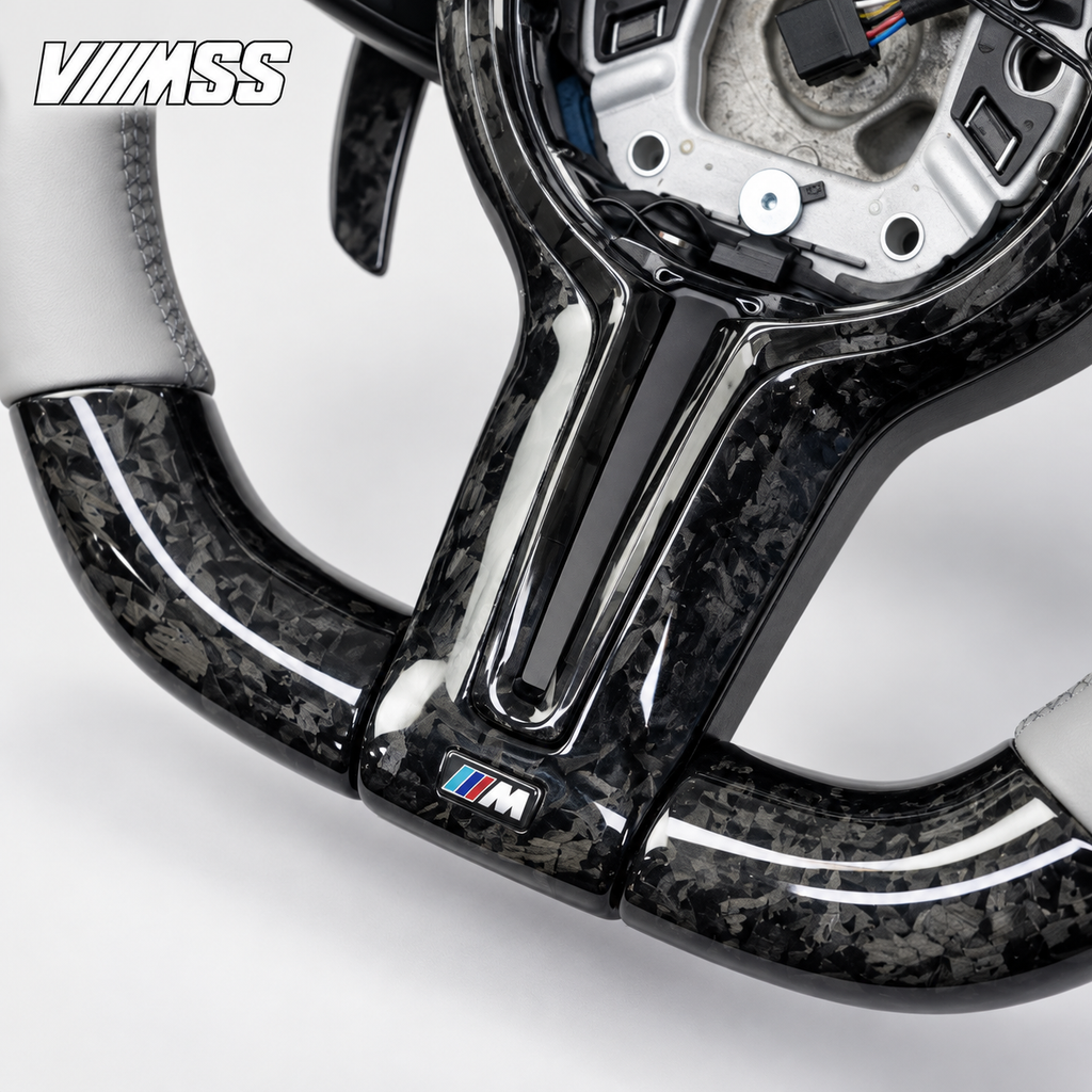 BMW F-Series Silver-Grey Leather & Forged Carbon LED Steering Wheel — Centre trim and lower rim detail; VMSS studio close-up