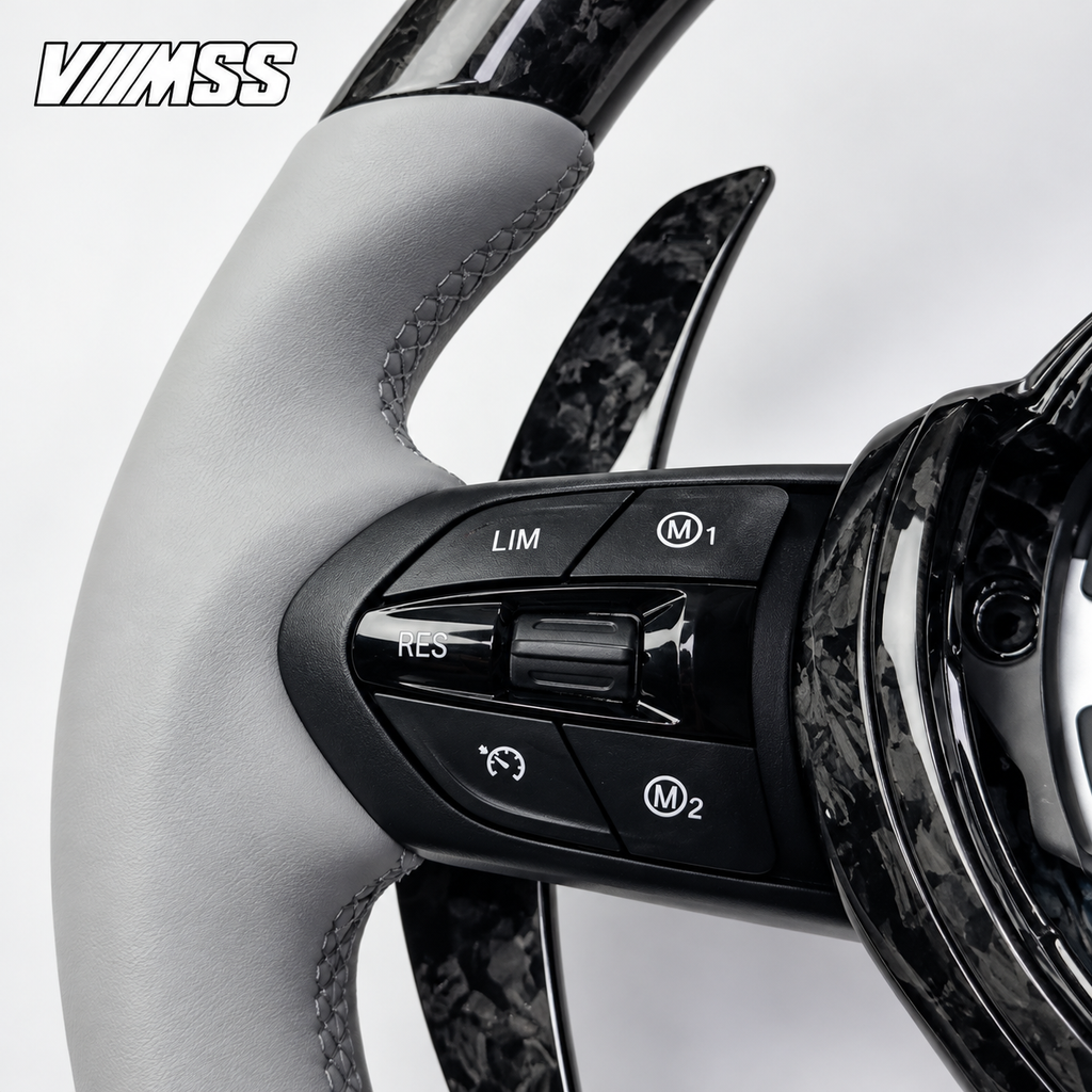 BMW F-Series Silver-Grey Leather & Forged Carbon LED Steering Wheel — Buttons and visible paddle detail; VMSS studio close-up