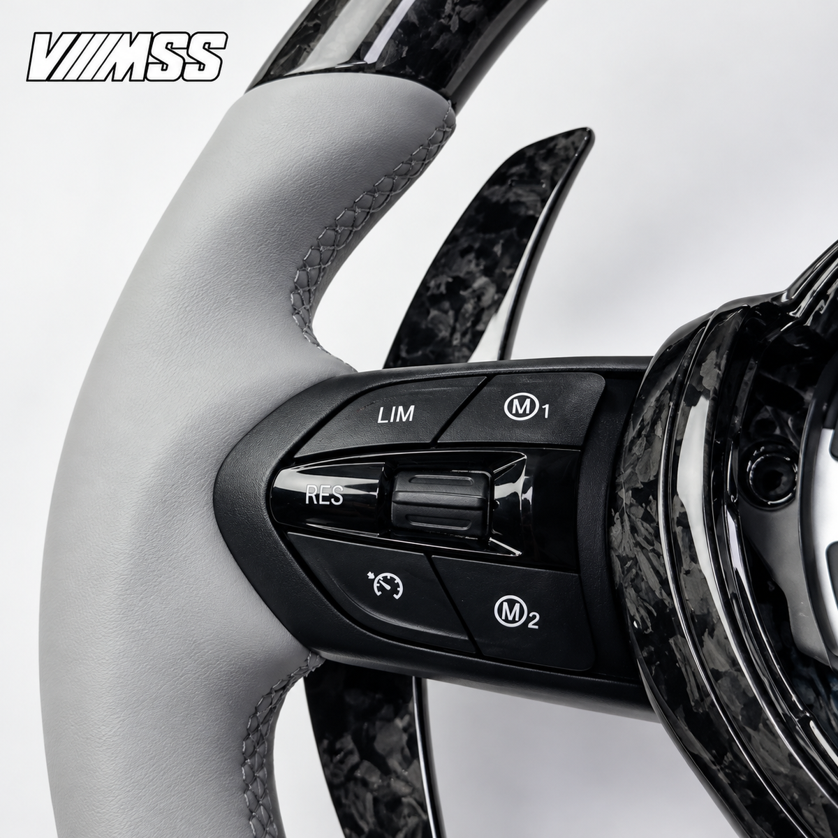 BMW F-Series Silver-Grey Leather & Forged Carbon LED Steering Wheel — Buttons and visible paddle detail; VMSS studio close-up