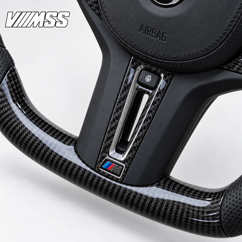 BMW G-Series Carbon Fibre & Perforated Leather Steering Wheel — Centre trim and lower rim detail; VMSS studio close-up