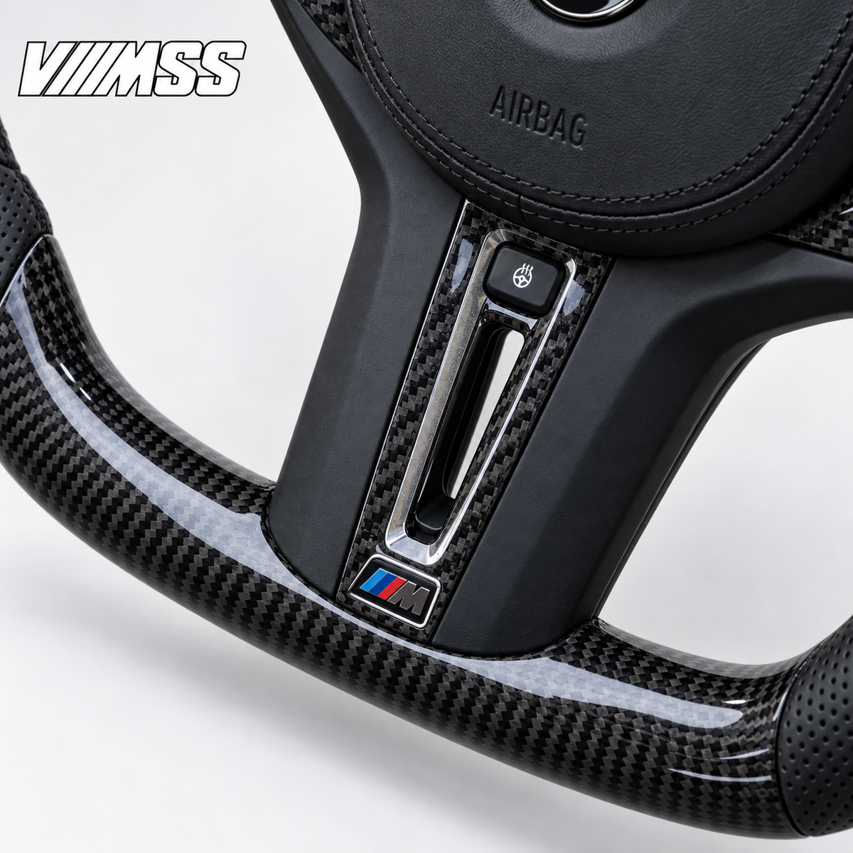 BMW G-Series Carbon Fibre & Perforated Leather Steering Wheel — Centre trim and lower rim detail; VMSS studio close-up