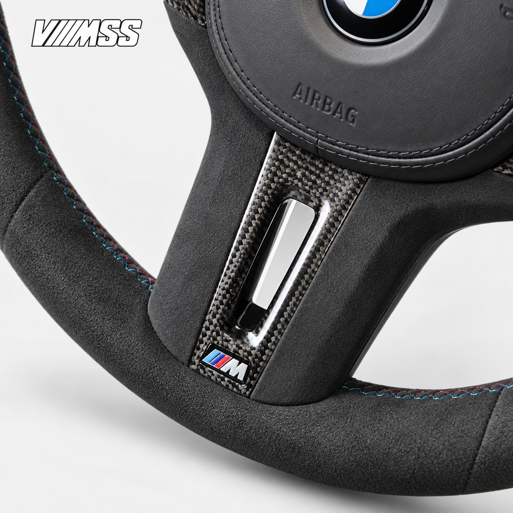 BMW G-Series Full Alcantara — Carbon Trim Steering Wheel — Centre trim and lower rim detail; VMSS studio close-up