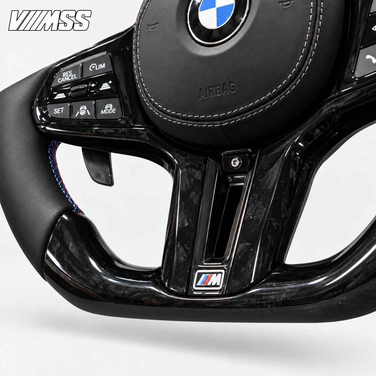 BMW G-Series Forged Carbon & Leather — M Stripe Steering Wheel — Centre trim and lower rim detail; VMSS studio close-up
