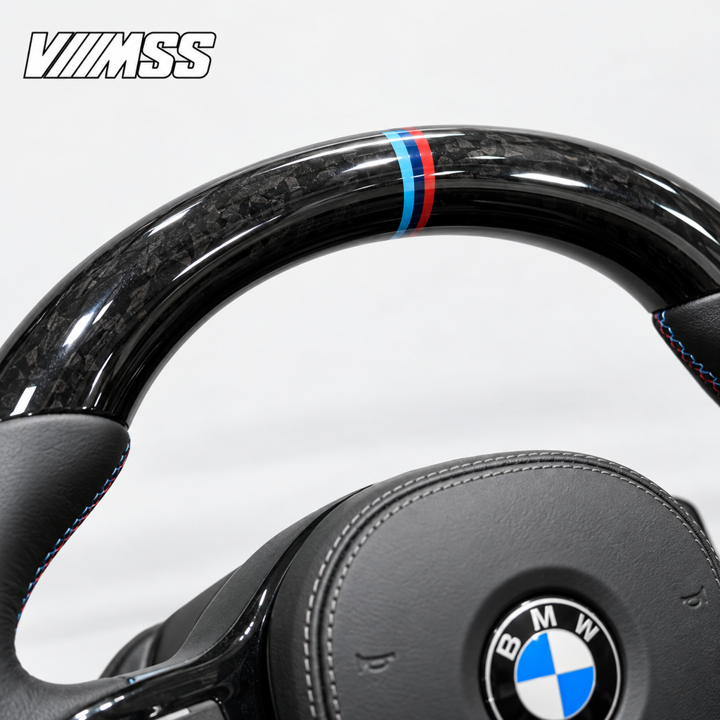 BMW G-Series Forged Carbon & Leather — M Stripe Steering Wheel — Upper rim and 12 o’clock detail; VMSS studio close-up